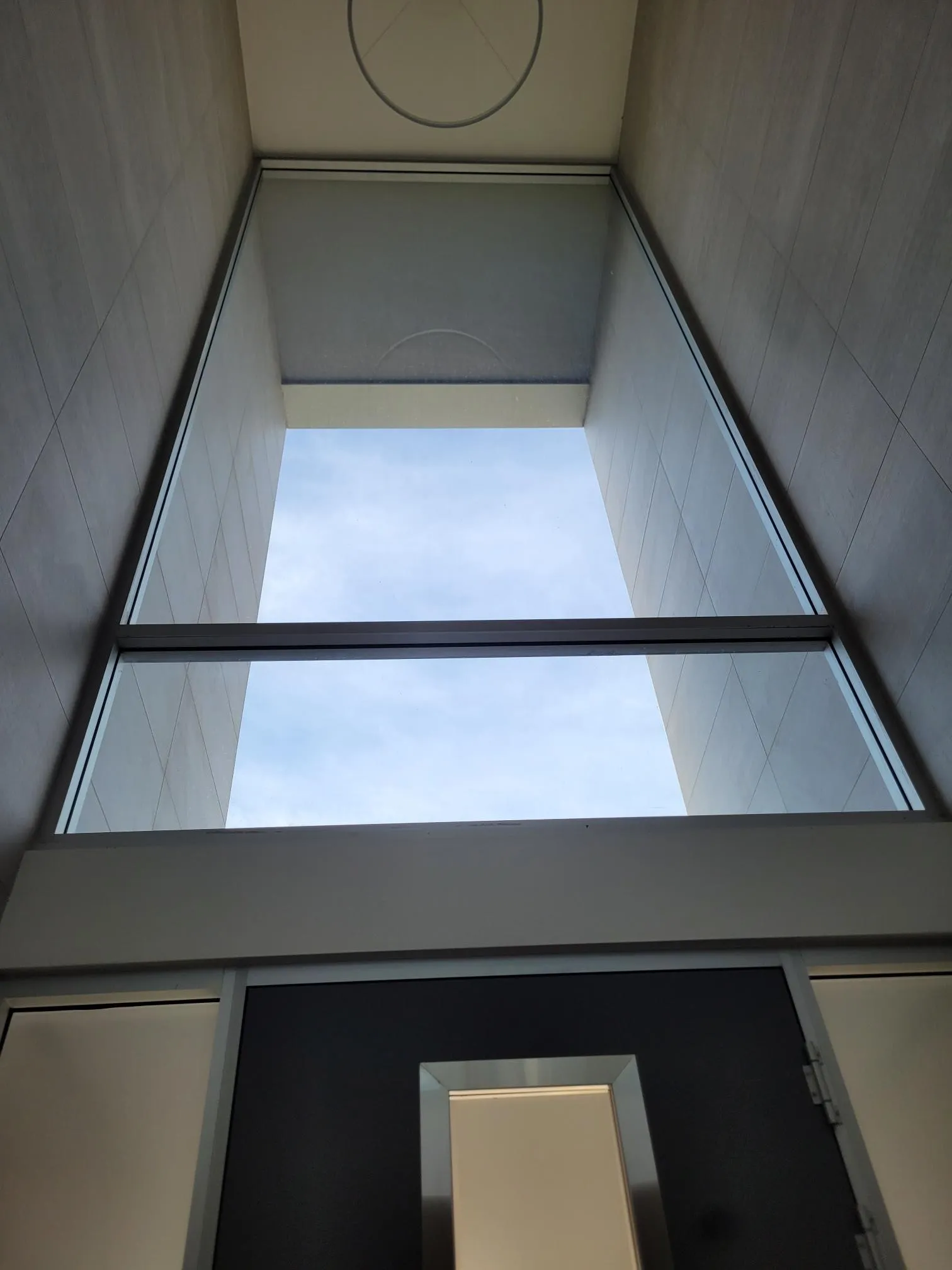 Skylight and atrium glass gleaming against a blue sky