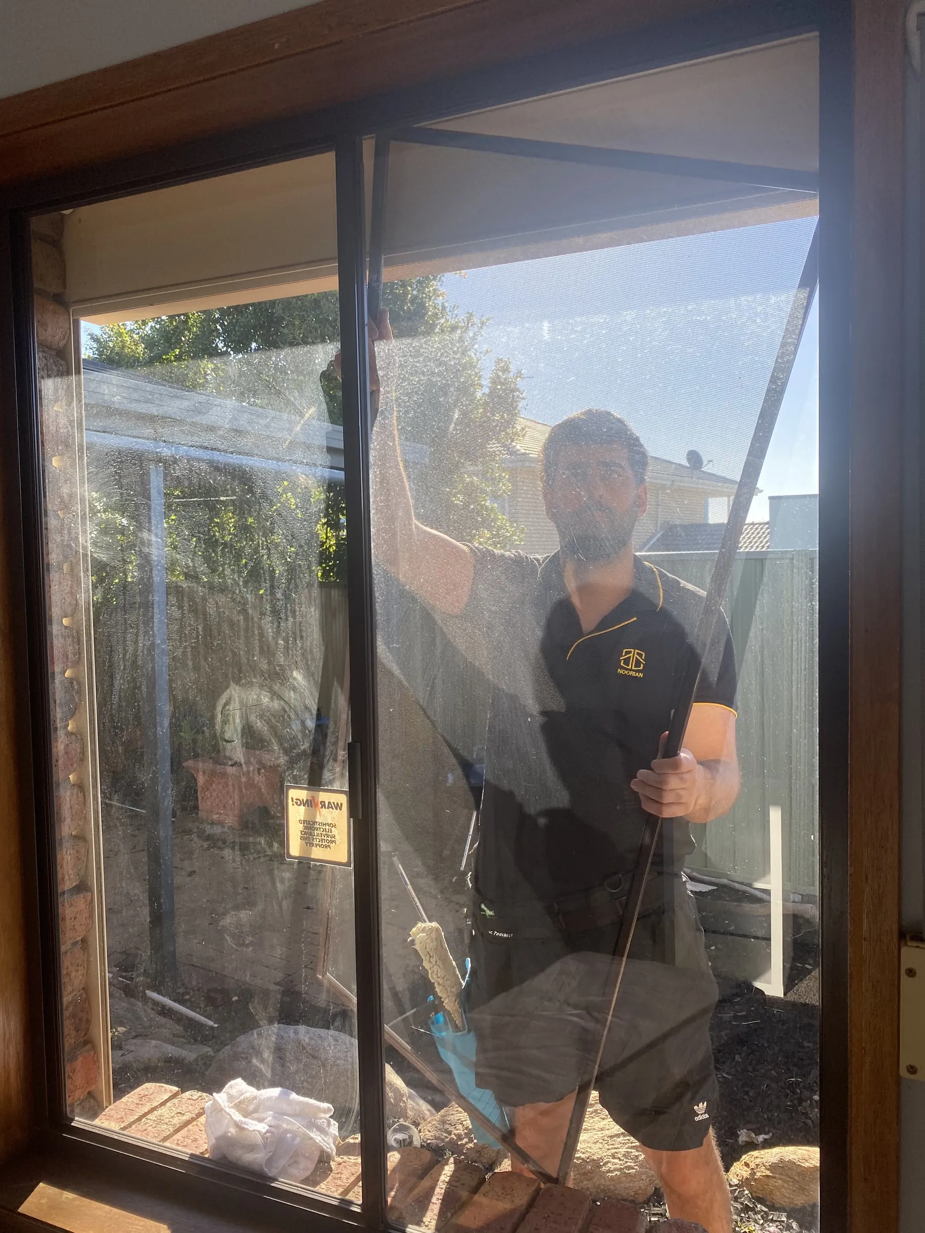 Window being cleaned, photographed through the glass