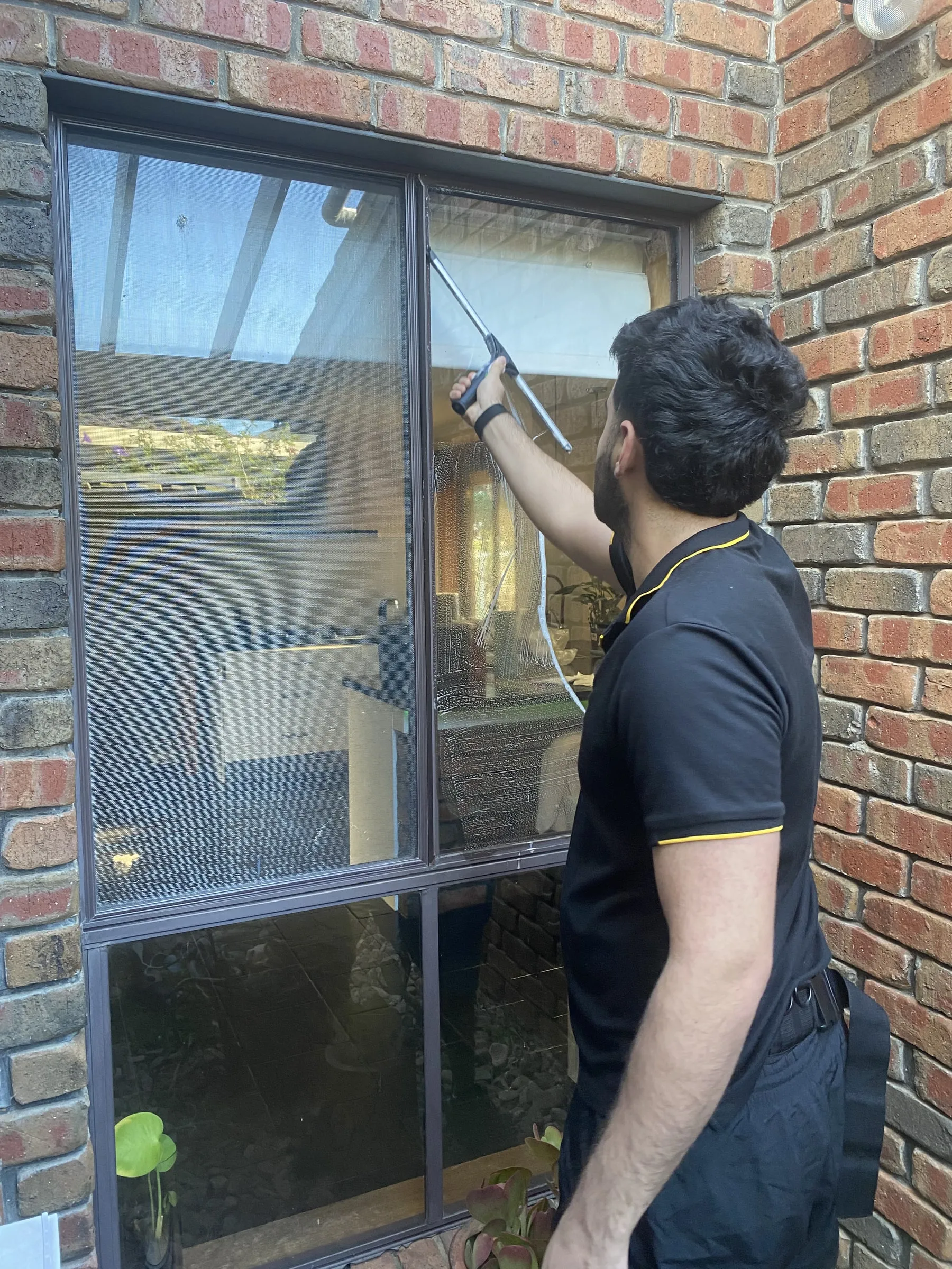 Ben squeegeeing a large sliding glass door