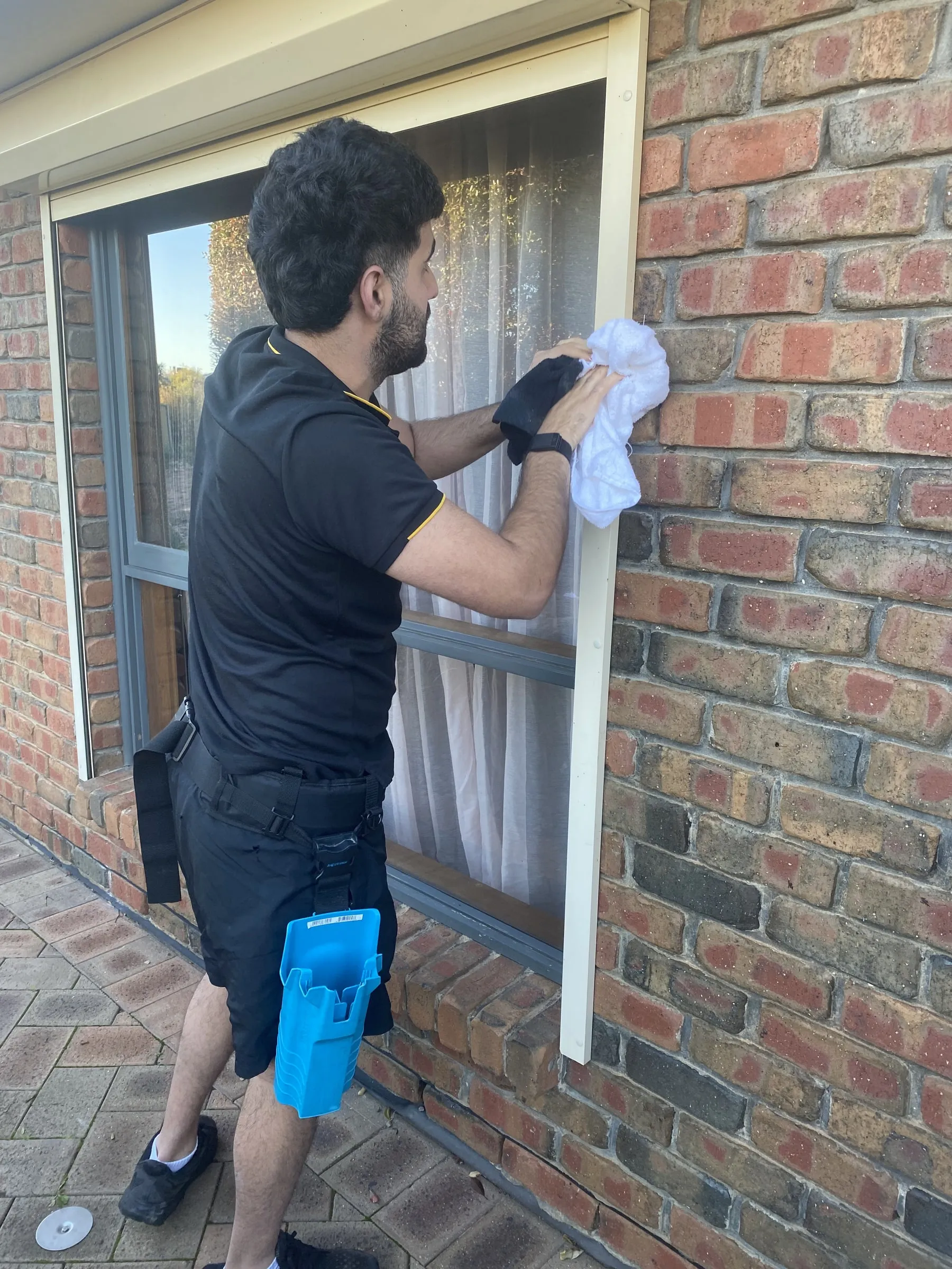 Wiping a window frame clean by hand